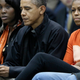 Obama checks an important presidential email while attending an NCAA basketball game.